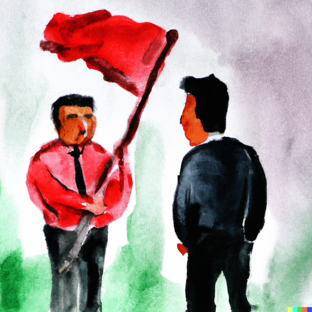 2 men talking while one holds a red flag