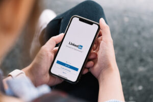 shot of a person opening linkedln app on their phone